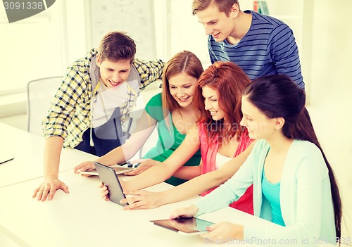 Image of smiling students with tablet pc at school