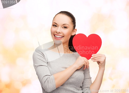 Image of smiling asian woman with red heart