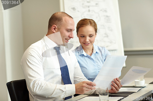 Image of smiling business people meeting in office