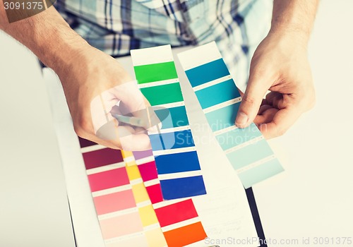 Image of man with color samples for selection