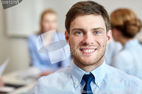 Image of smiling businessman face in office