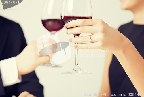 Image of engaged couple with wine glasses