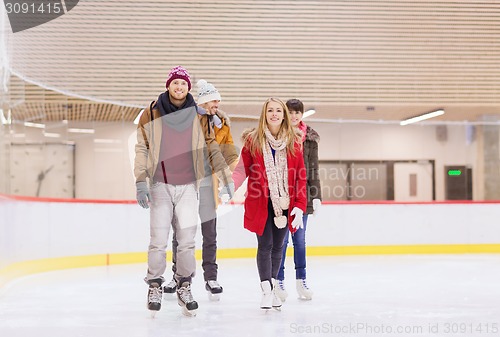 Image of happy friends on skating rink