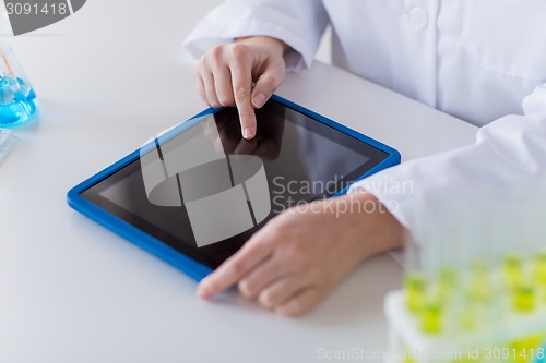 Image of close up of scientist with tablet pc in lab