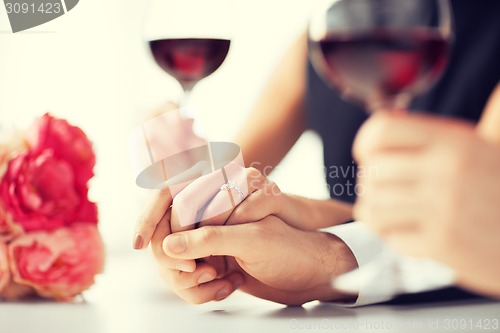 Image of engaged couple with wine glasses