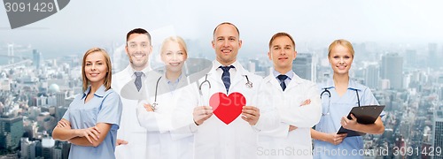 Image of group of smiling doctors with red heart shape