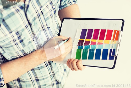 Image of man with color samples for selection