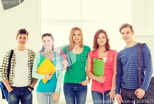 Image of smiling students with bags and folders at school