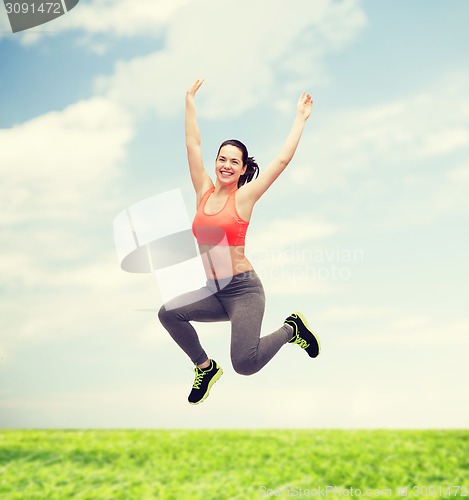 Image of sporty teenage girl jumping in sportswear