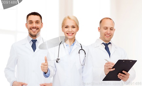 Image of group of doctors showing thumbs up in clinic