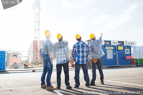 Image of group of builders in hardhats outdoors