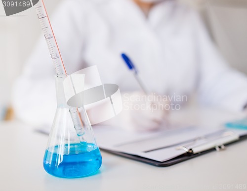 Image of close up of scientist making test in laboratory