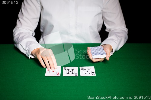 Image of holdem dealer with playing cards