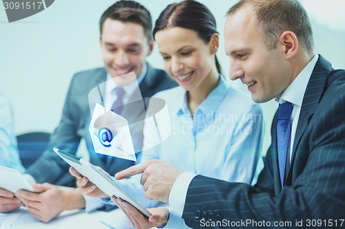 Image of business team with tablet pc having discussion