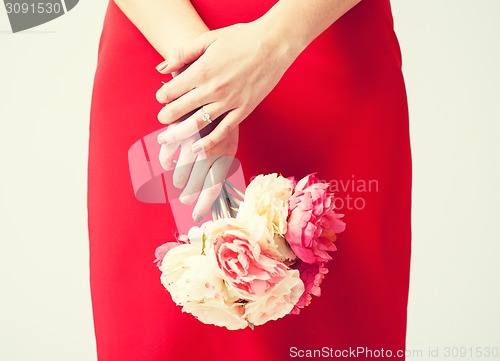 Image of woman hands with flowers and ring