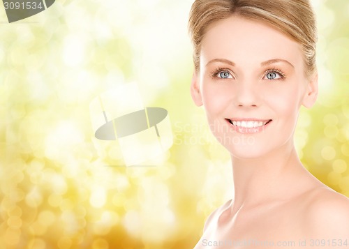 Image of close up of smiling woman over yellow background