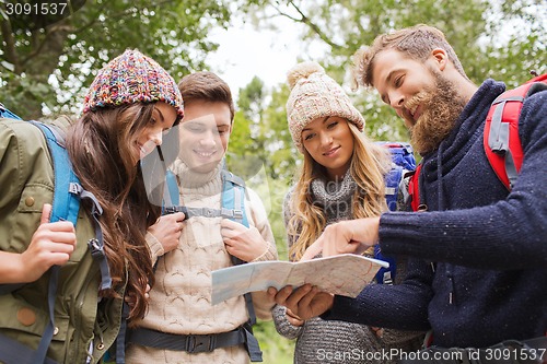 Image of group of smiling friends with backpacks hiking