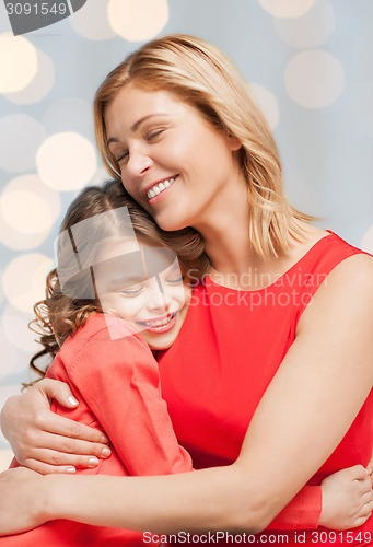 Image of happy mother and daughter hugging