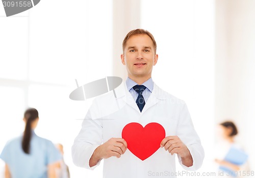 Image of smiling male doctor with red heart