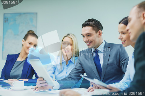 Image of business team with tablet pc having discussion