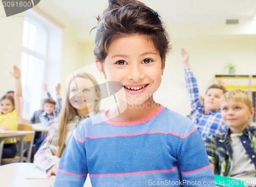 Image of little school girl over classroom background