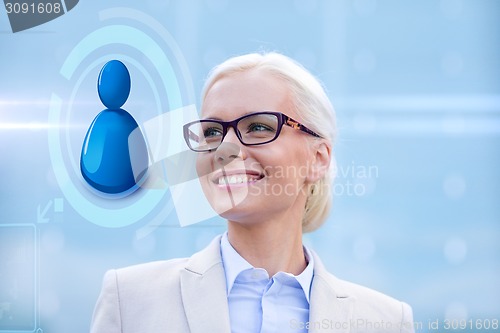 Image of young smiling businesswoman in eyeglasses outdoors