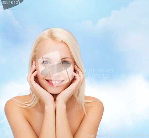 Image of beautiful woman touching her face skin