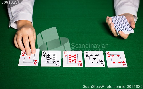 Image of holdem dealer with playing cards