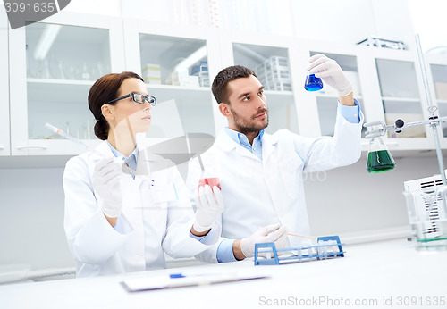Image of young scientists making test or research in lab