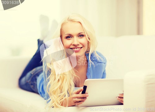 Image of smiling woman with tablet pc computer at home