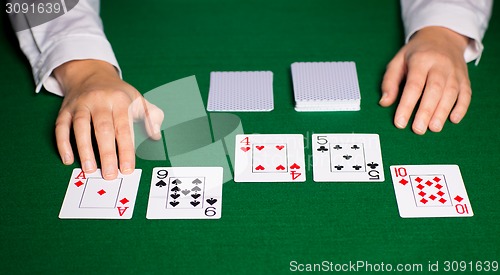 Image of holdem dealer with playing cards
