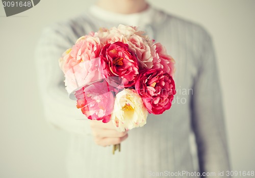 Image of man giving bouquet of flowers