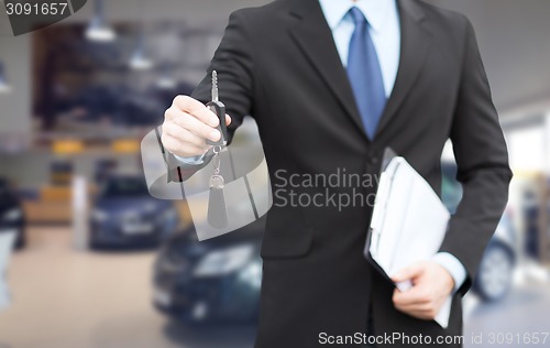 Image of close up of businessman or salesman giving car key