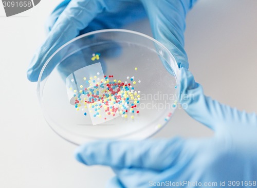 Image of close up of scientist hands holding chemical cure
