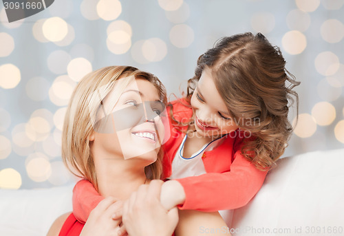 Image of happy mother with daughter hugging and talking