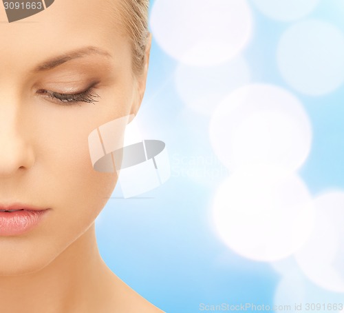 Image of beautiful young woman half face