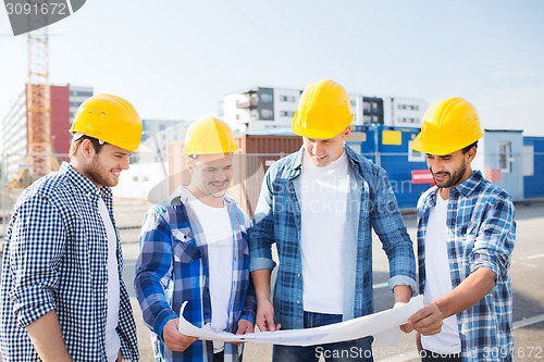 Image of group of builders with tablet pc and blueprint