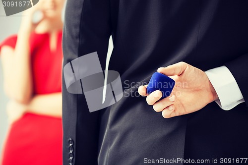 Image of man with wedding ring and gift box