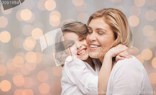 Image of happy mother and daughter hugging