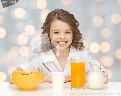 Image of happy girl eating healthy breakfast