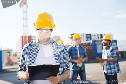 Image of group of builders in hardhats outdoors