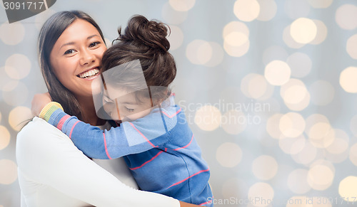 Image of happy mother and daughter hugging