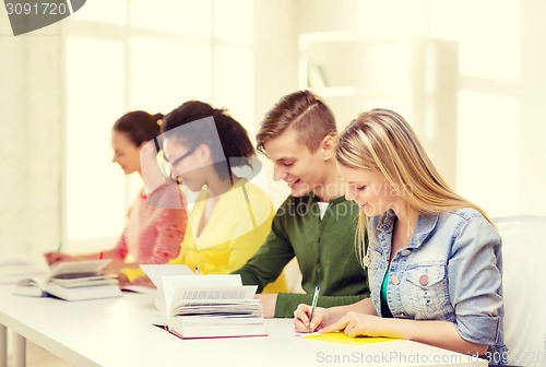 Image of students with textbooks and books at school