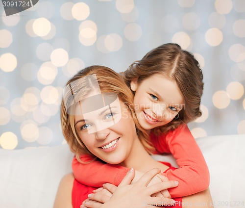 Image of happy mother with daughter hugging and talking