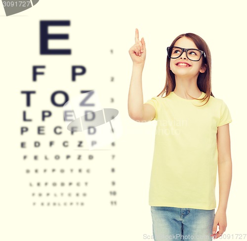 Image of smiling cute little girl in black eyeglasses