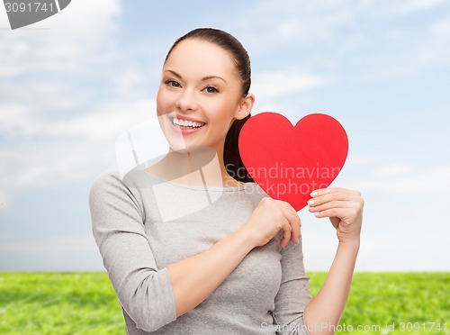 Image of smiling asian woman with red heart