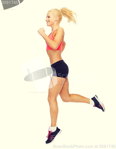 Image of sporty woman running or jumping