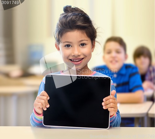 Image of little school girl with tablet pc over classroom