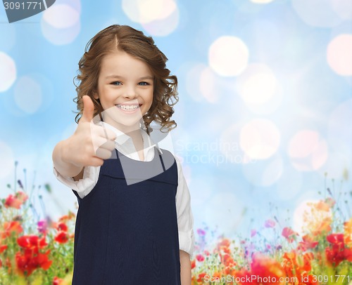 Image of happy little school girl showing thumbs up