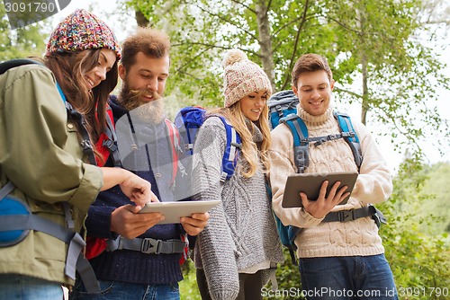 Image of group of friends with backpacks and tablet pc